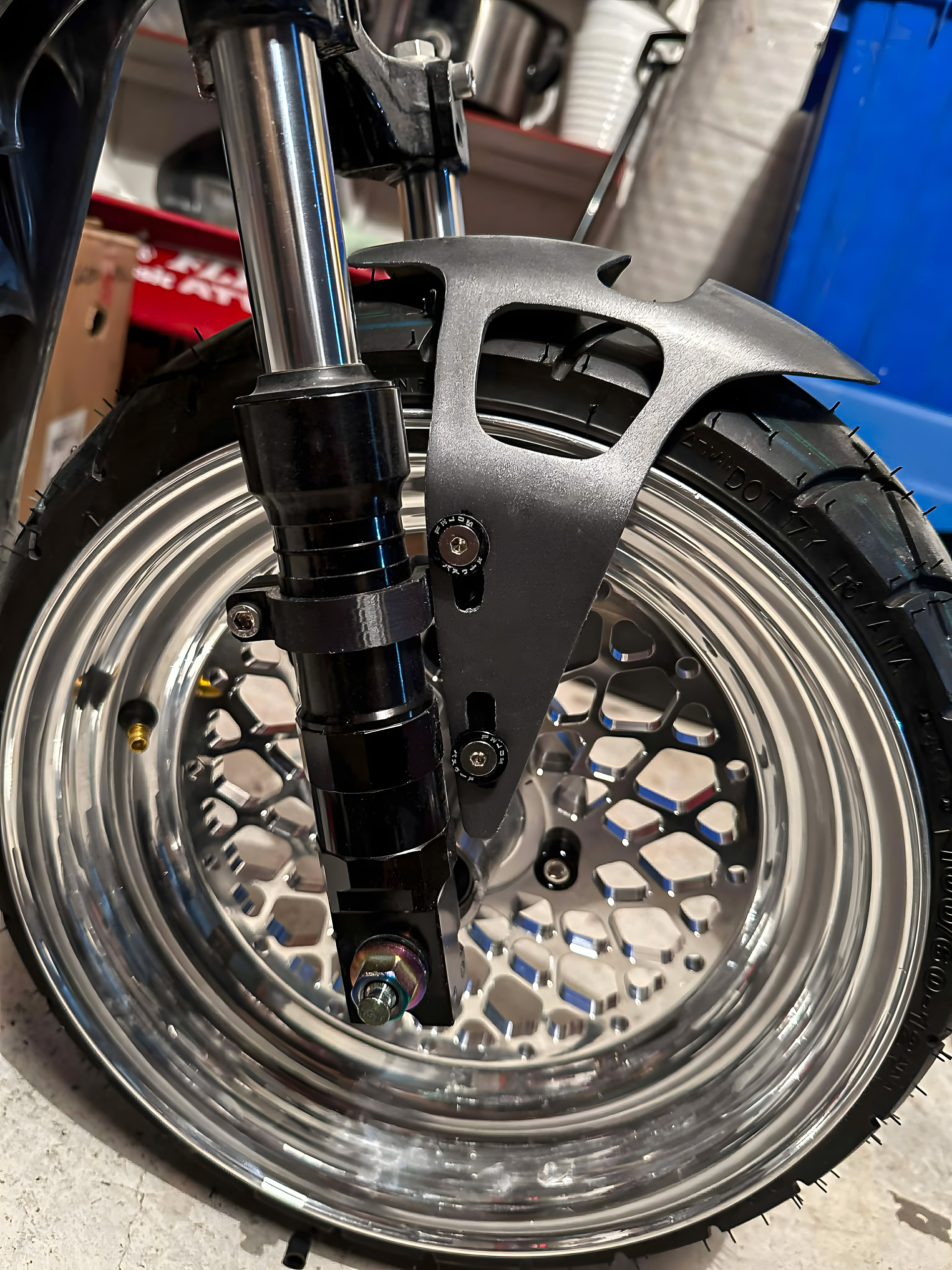 3D printed motorcycle brake caliper brackets installed on wheel
